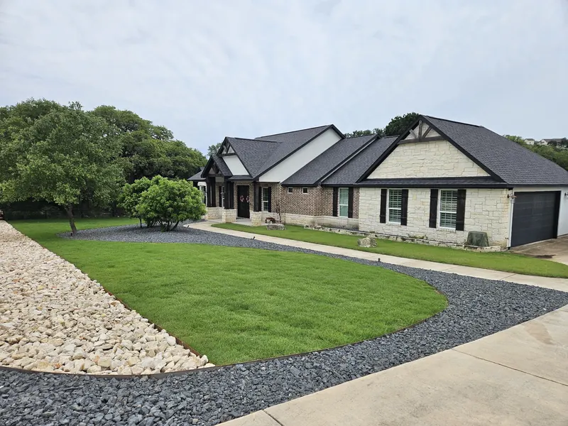 Fresh lawn with clean gravel border in Spring Branch, TX by CJK Landscaping