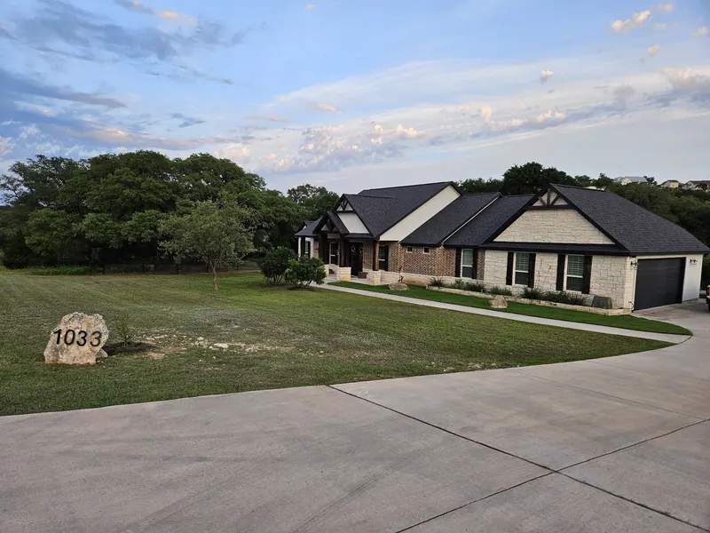 Maintained front lawn at dusk in Spring Branch, TX by CJK Landscaping