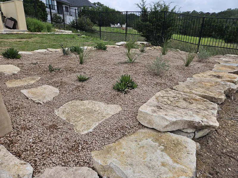 Xeriscape rock garden with flagstone and native plantings in Spring Branch, TX by CJK Landscaping